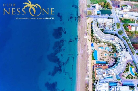 Exterior of Club Hotel Casino Loutraki with beachfront location and palm trees in Loutraki, Greece